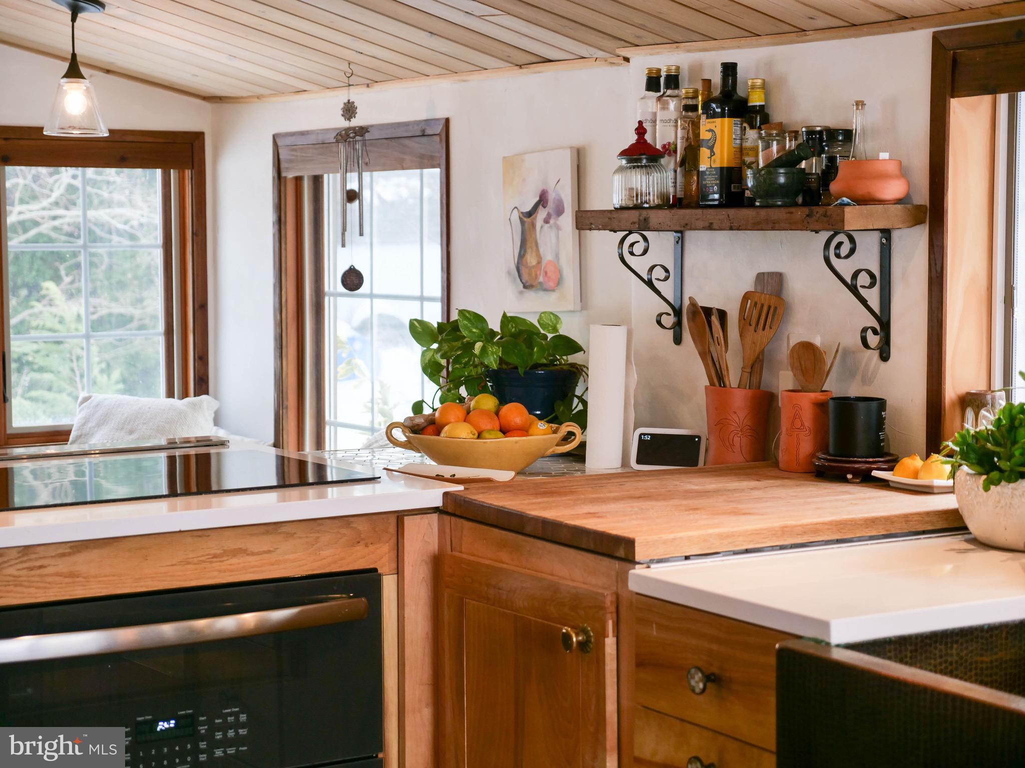 20800 Bivalve Wharf Road Bivalve, MD 21865 - Photo 10 of 31 a room with kitchen island granite countertop a refrigerator and a sink
