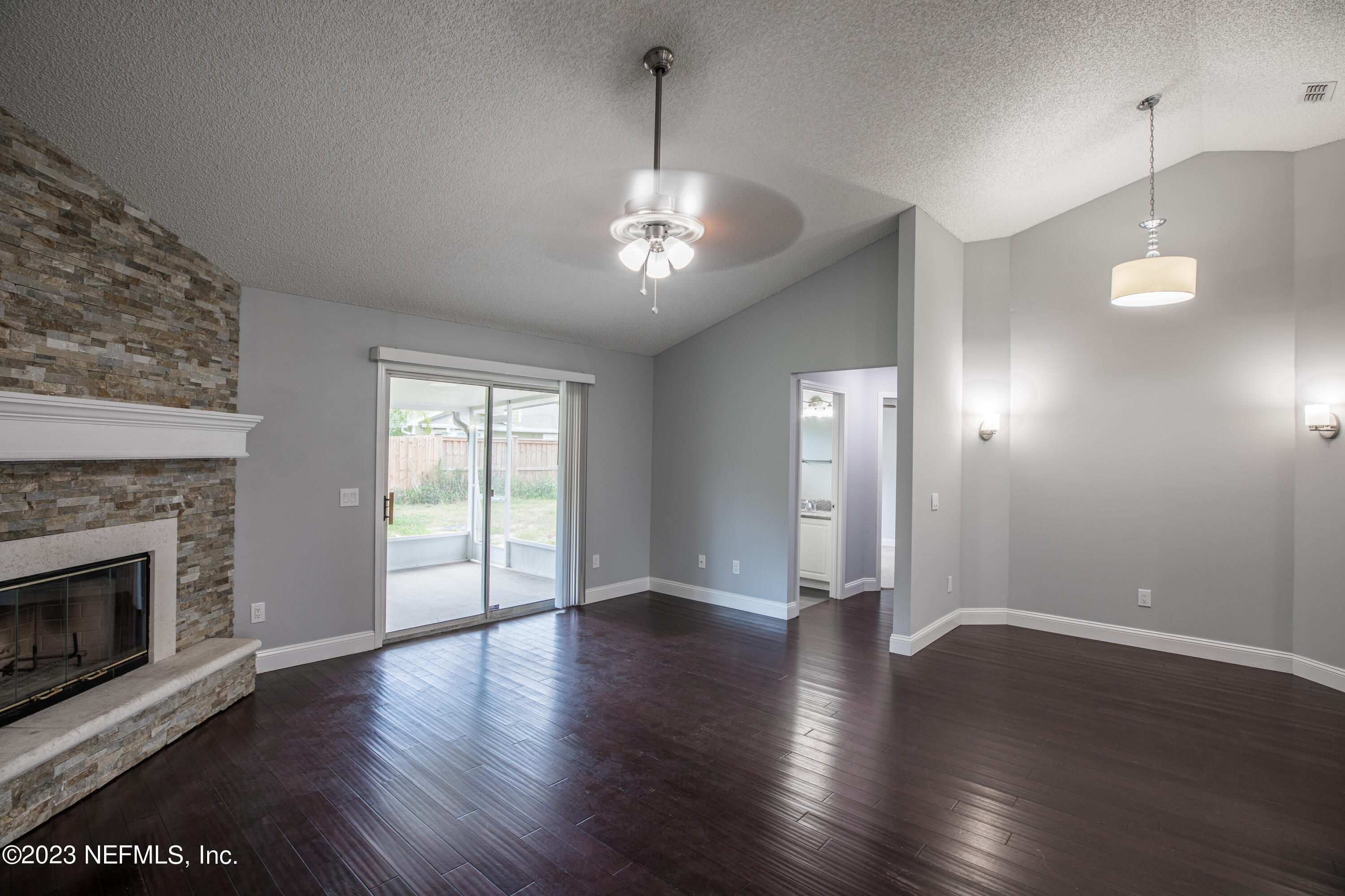 13607 Capistrano Drive South Jacksonville, FL 32224 - Photo 12 of 24 a view of an empty room with wooden floor fireplace and a window