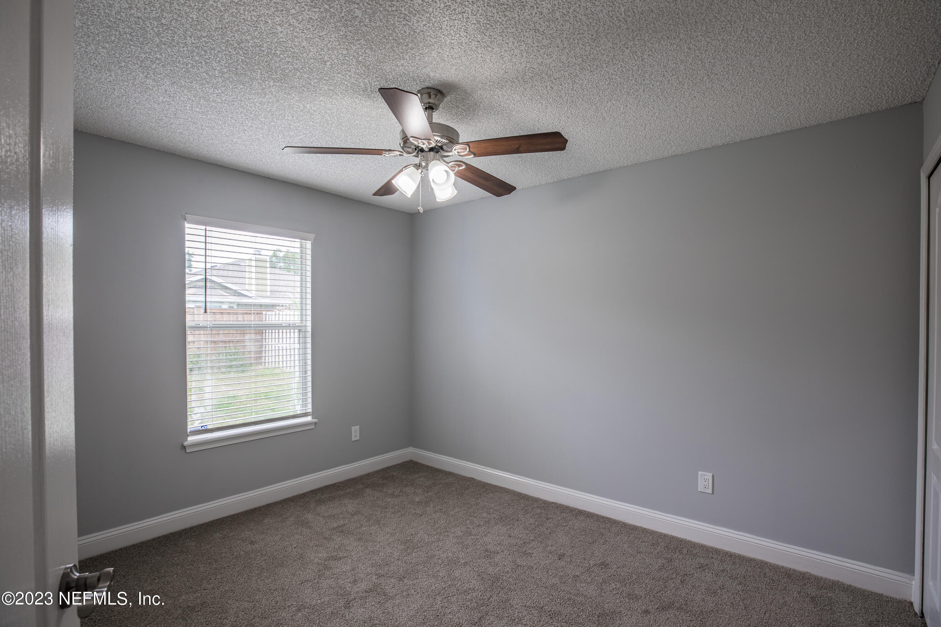 13607 Capistrano Drive South Jacksonville, FL 32224 - Photo 19 of 24 an empty room with a window and a fan