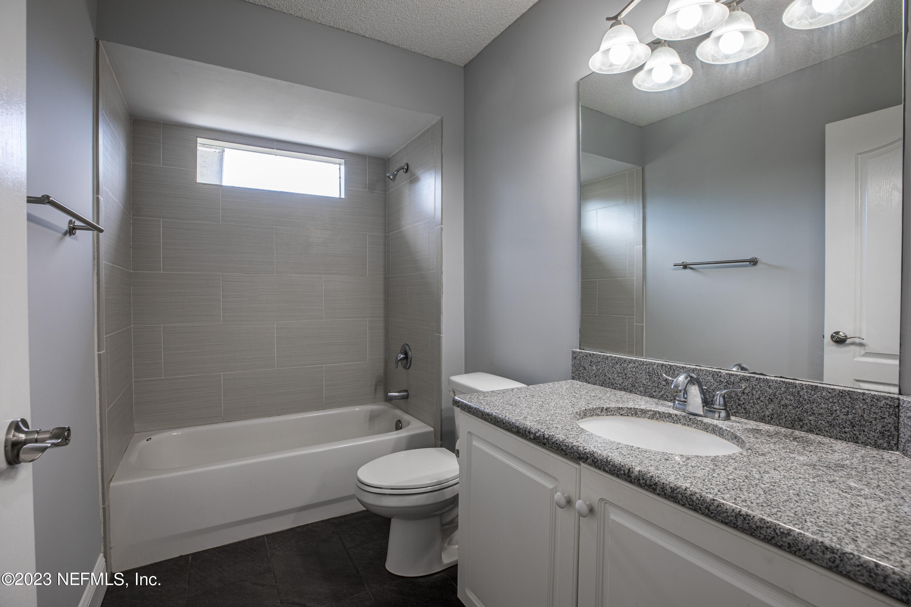 13607 Capistrano Drive South Jacksonville, FL 32224 - Photo 20 of 24 a bathroom with a granite countertop sink a toilet and bathtub