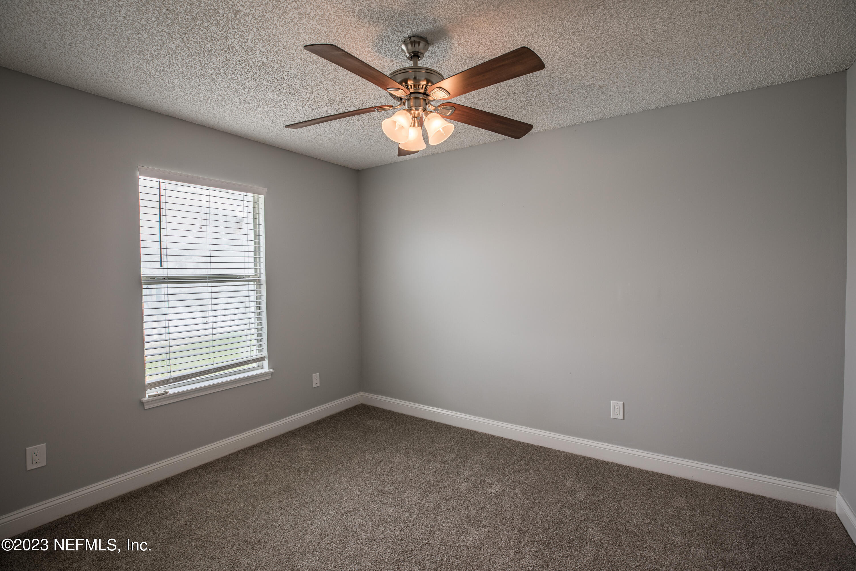 13607 Capistrano Drive South Jacksonville, FL 32224 - Photo 21 of 24 an empty room with windows and fan