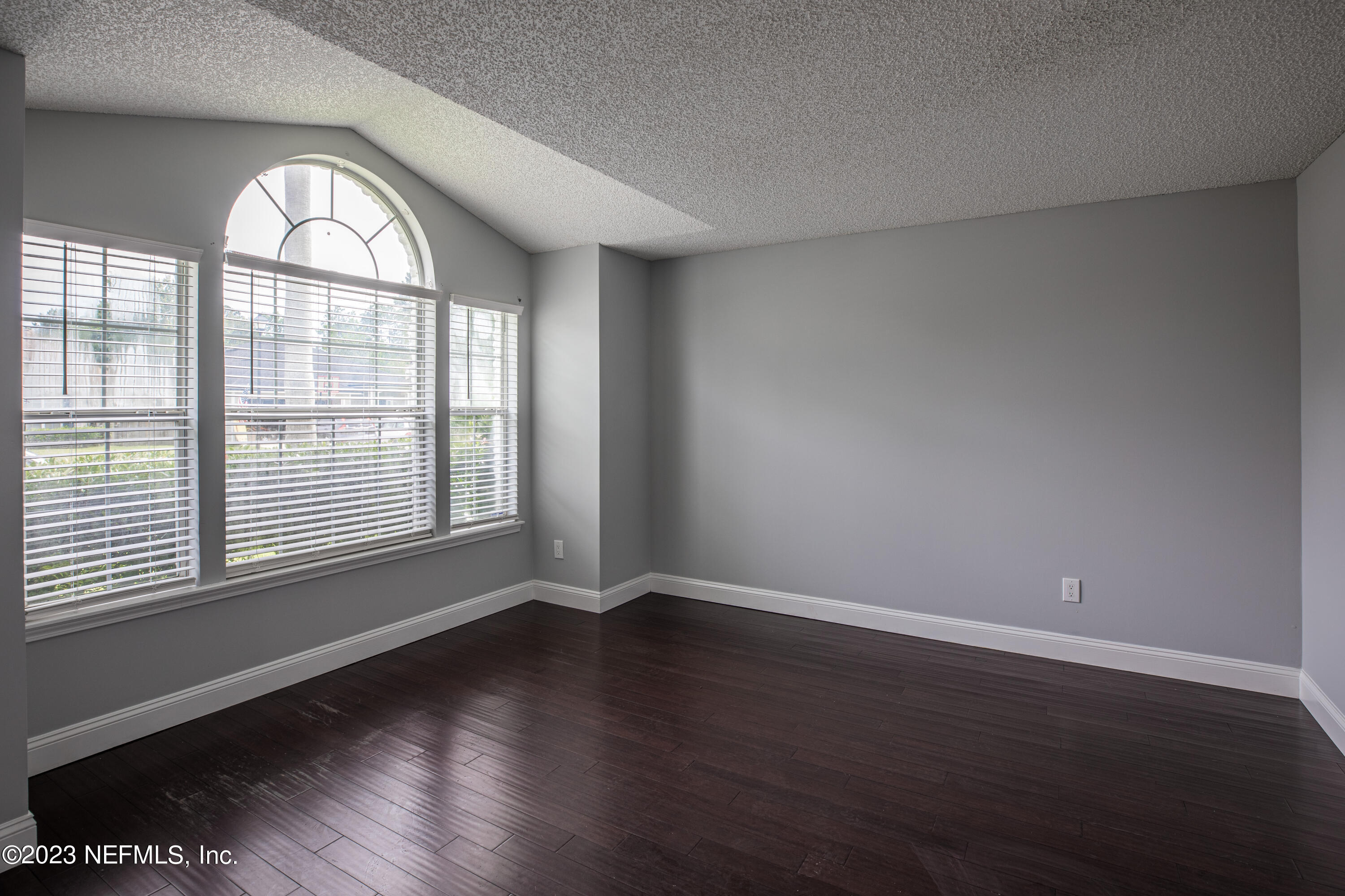 13607 Capistrano Drive South Jacksonville, FL 32224 - Photo 5 of 24 a view of an empty room with wooden floor and a window