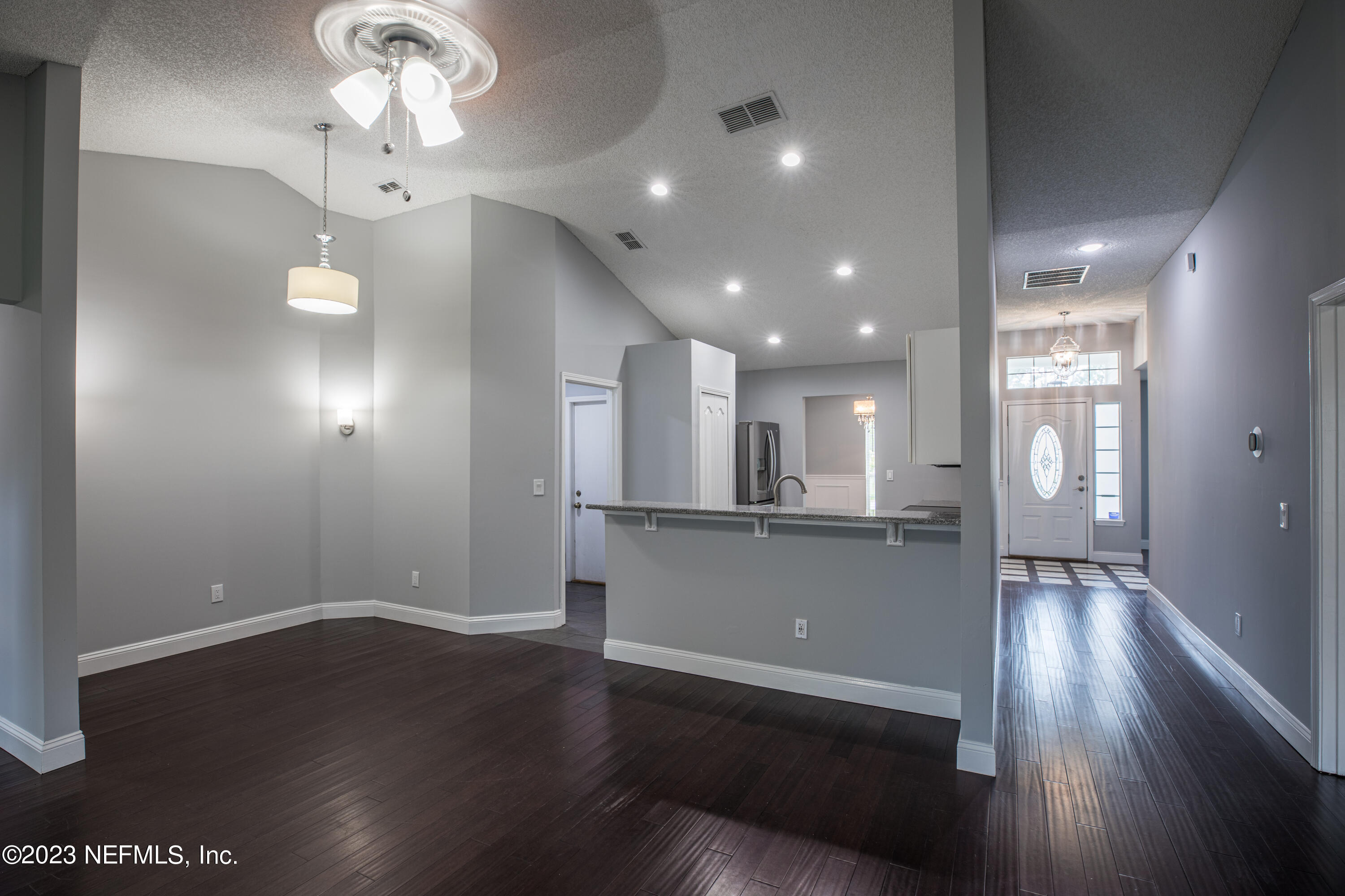 13607 Capistrano Drive South Jacksonville, FL 32224 - Photo 7 of 24 a view of a room with wooden floor and a ceiling fan
