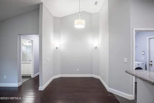 a view of a room with wooden floor and staircase