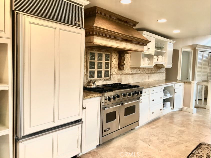 821 Emerald Bay Laguna Beach, CA 92651 - Photo 6 of 15 a kitchen with a stove and a white refrigerator