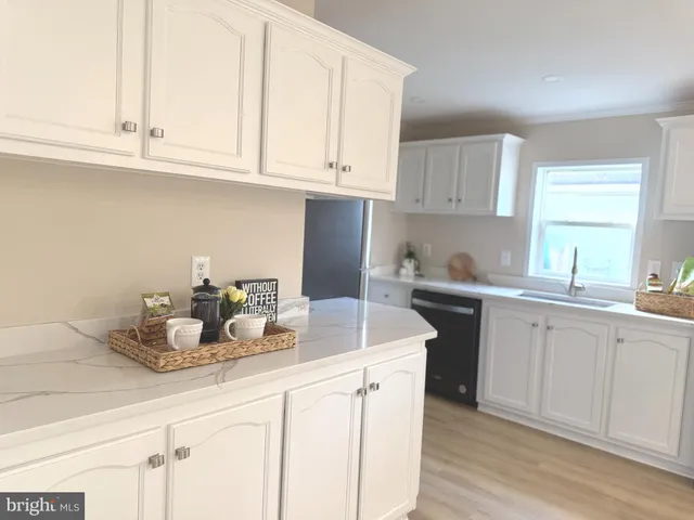 a kitchen with white cabinets and a sink