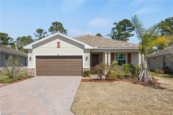 a front view of house with yard and seating space
