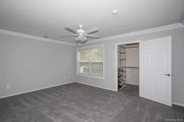 an empty room with windows and closet