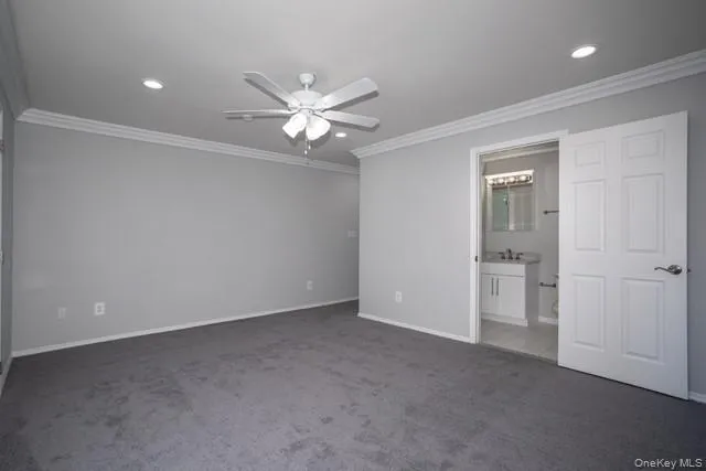 an empty room with closet and a ceiling fan
