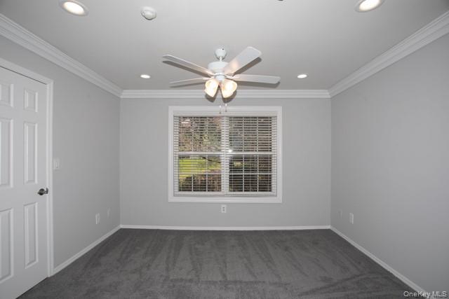 69 Overlook Drive, Unit 69 Farmingville, NY 11738 - Photo 7 of 16 an empty room with chandelier fan and windows