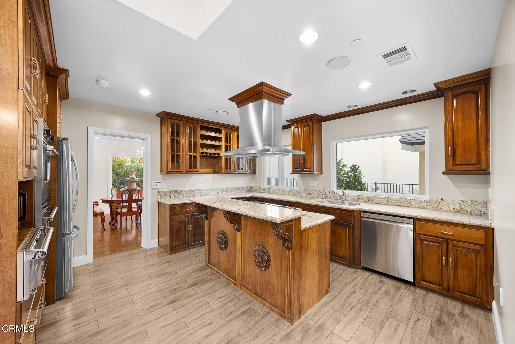 450 Allendale Road Pasadena, CA 91106 - Photo 20 of 57 a kitchen with stainless steel appliances granite countertop wooden cabinets a sink dishwasher and a stove top oven