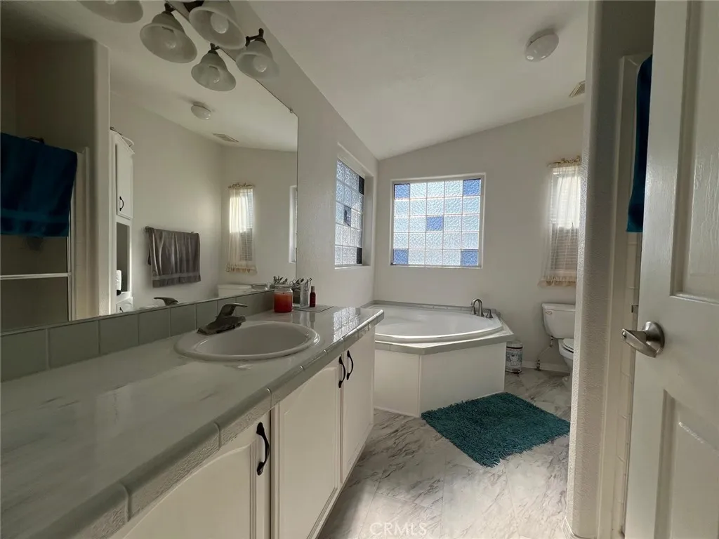 10550 Western, Unit 43 Stanton, CA 90680 - Photo 12 of 27 a bathroom with a sink double vanity granite tub and shower