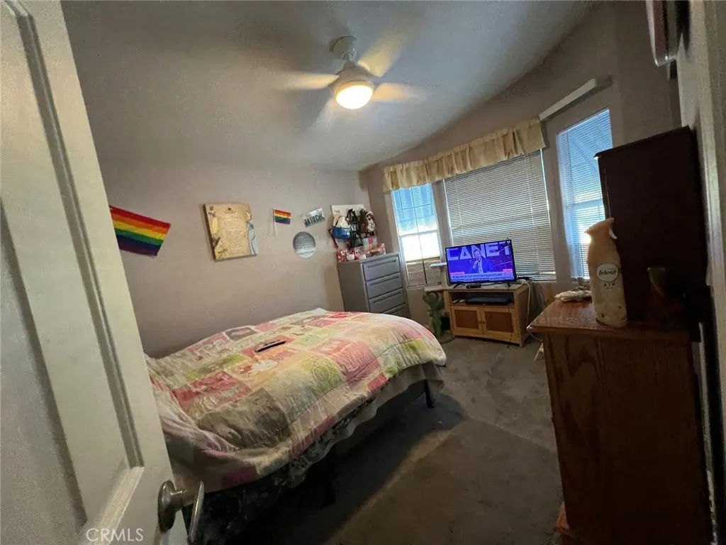 10550 Western, Unit 43 Stanton, CA 90680 - Photo 14 of 27 a bedroom with bed and a flat tv screen