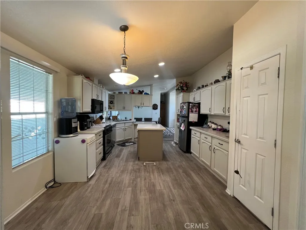 10550 Western, Unit 43 Stanton, CA 90680 - Photo 20 of 27 a kitchen with stainless steel appliances granite countertop a refrigerator a sink dishwasher a stove and white cabinets with wooden floor
