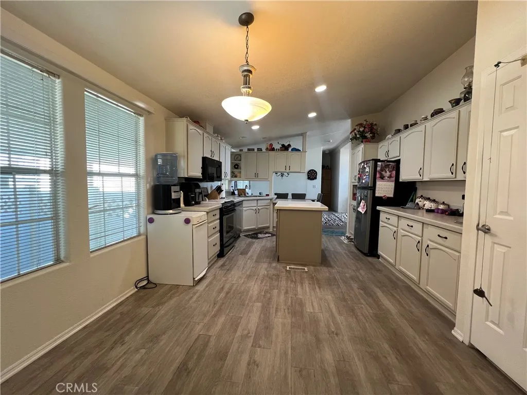 10550 Western, Unit 43 Stanton, CA 90680 - Photo 24 of 27 a kitchen with cabinets a counter top space a sink and stainless steel appliances