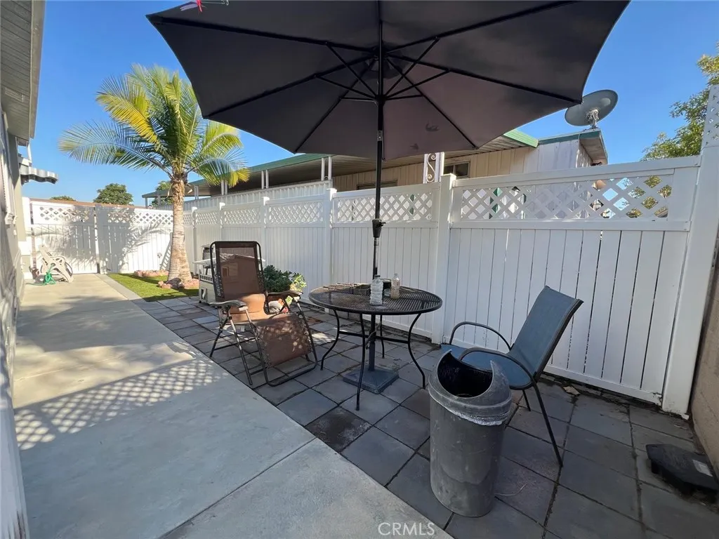 10550 Western, Unit 43 Stanton, CA 90680 - Photo 5 of 27 a view of a patio with table and chairs under an umbrella