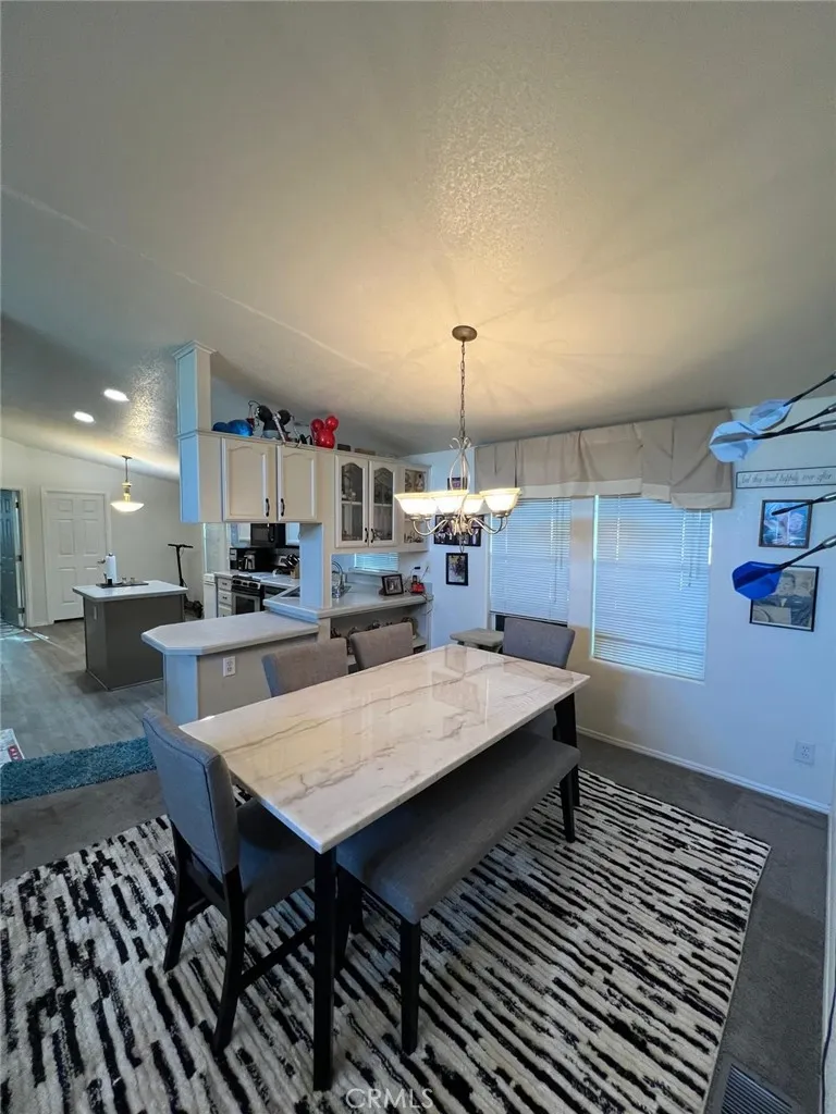 10550 Western, Unit 43 Stanton, CA 90680 - Photo 8 of 27 a room with stainless steel appliances kitchen island a wooden table and chairs