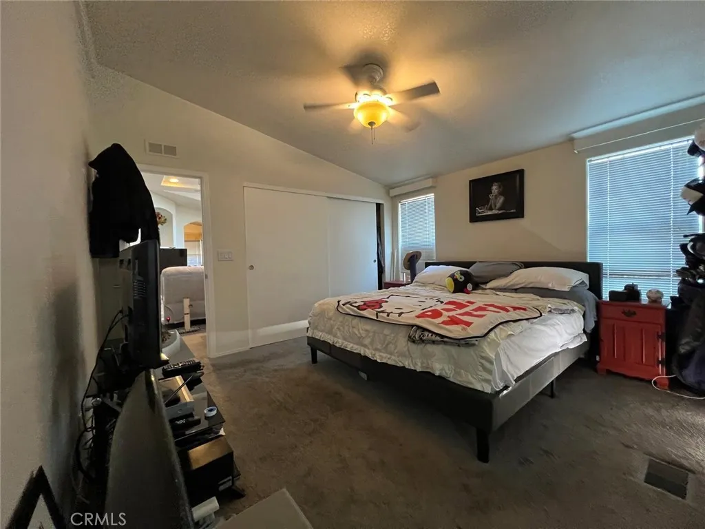 10550 Western, Unit 43 Stanton, CA 90680 - Photo 10 of 27 a bedroom with a bed and a chandelier