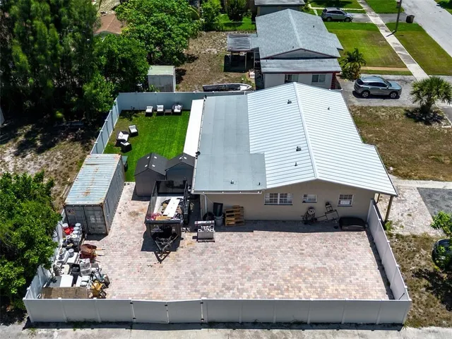 an aerial view of a house with a yard and sitting space