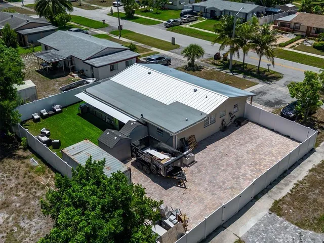 an aerial view of a backyard with a patio
