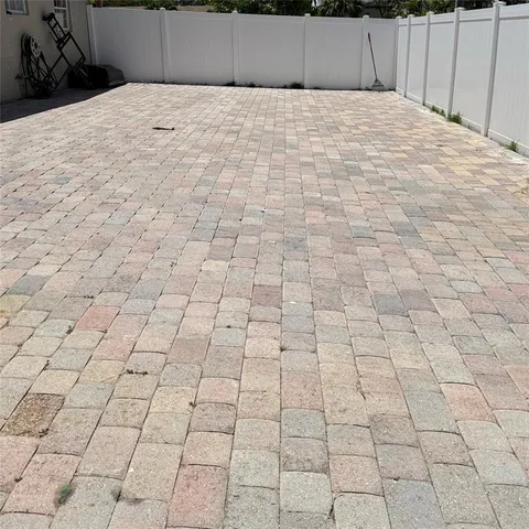 a backyard of a house with table and chairs a barbeque