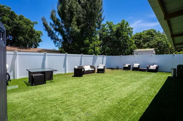 a backyard of a house with table and chairs