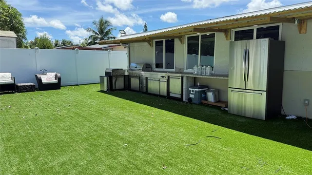 a view of a house with backyard and porch