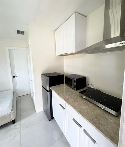 a kitchen with a sink and a stove top oven
