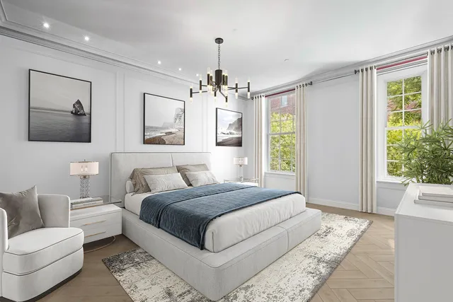 a bedroom with a large bed couch and a window