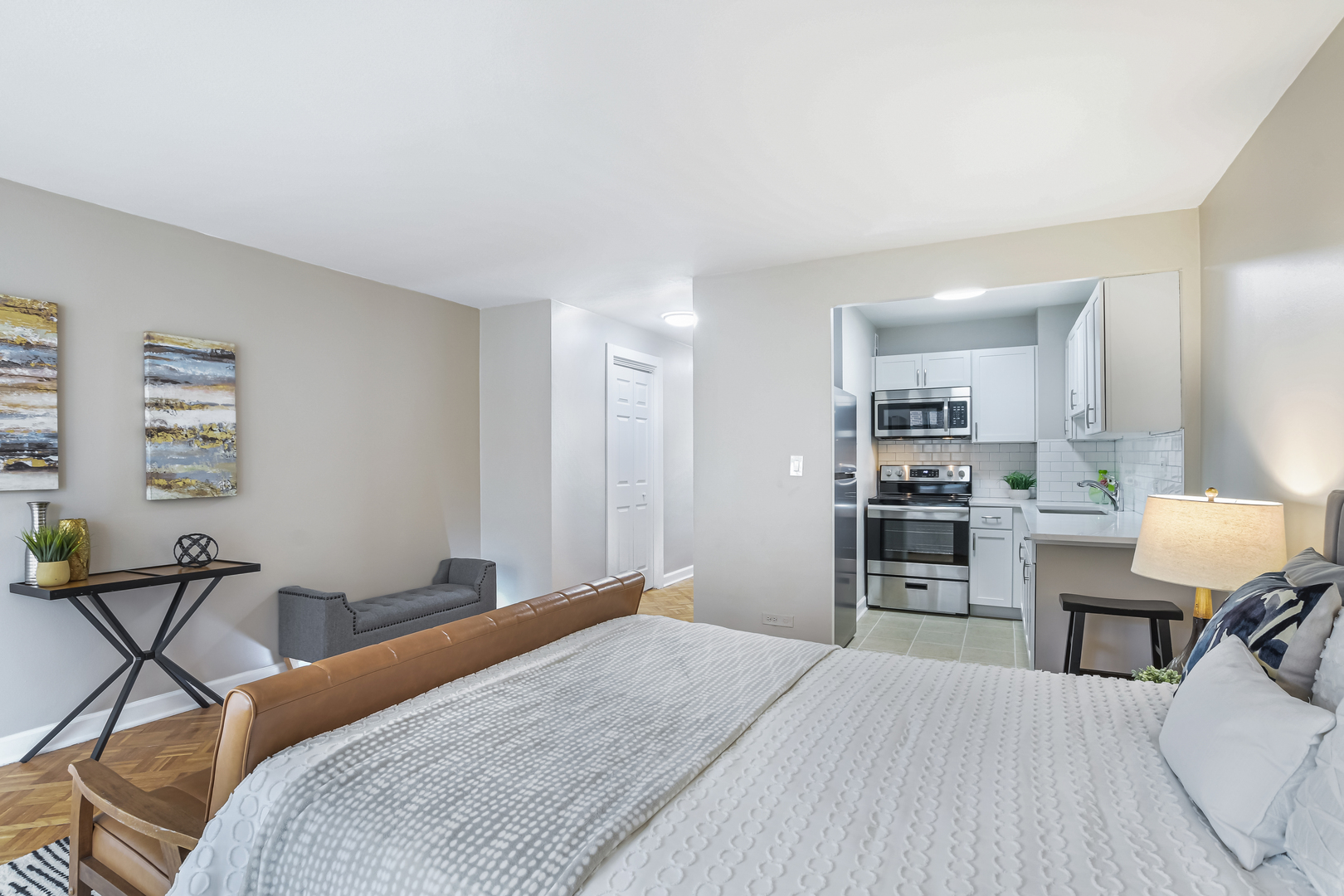 21 West Goethe Street, Unit 14D Chicago, IL 60610 - Photo 12 of 28 a bedroom with a bed and a table in it