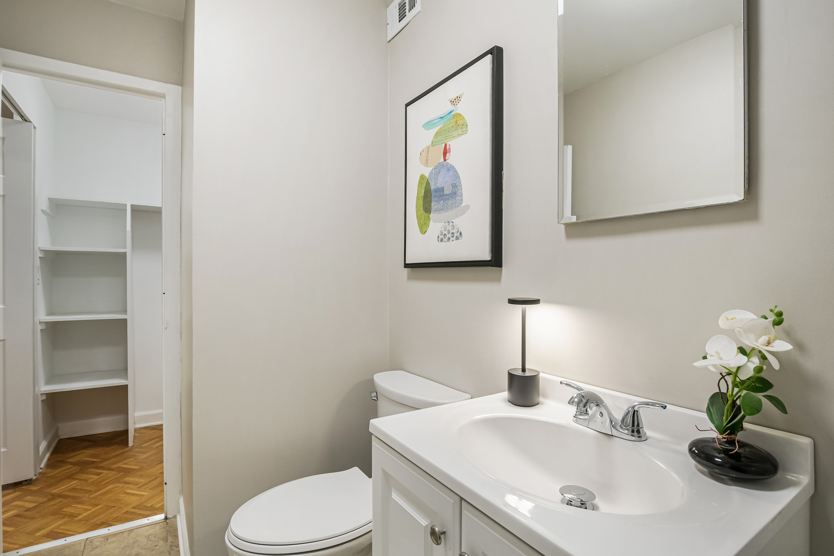 21 West Goethe Street, Unit 14D Chicago, IL 60610 - Photo 18 of 28 a bathroom with a sink a toilet and a mirror