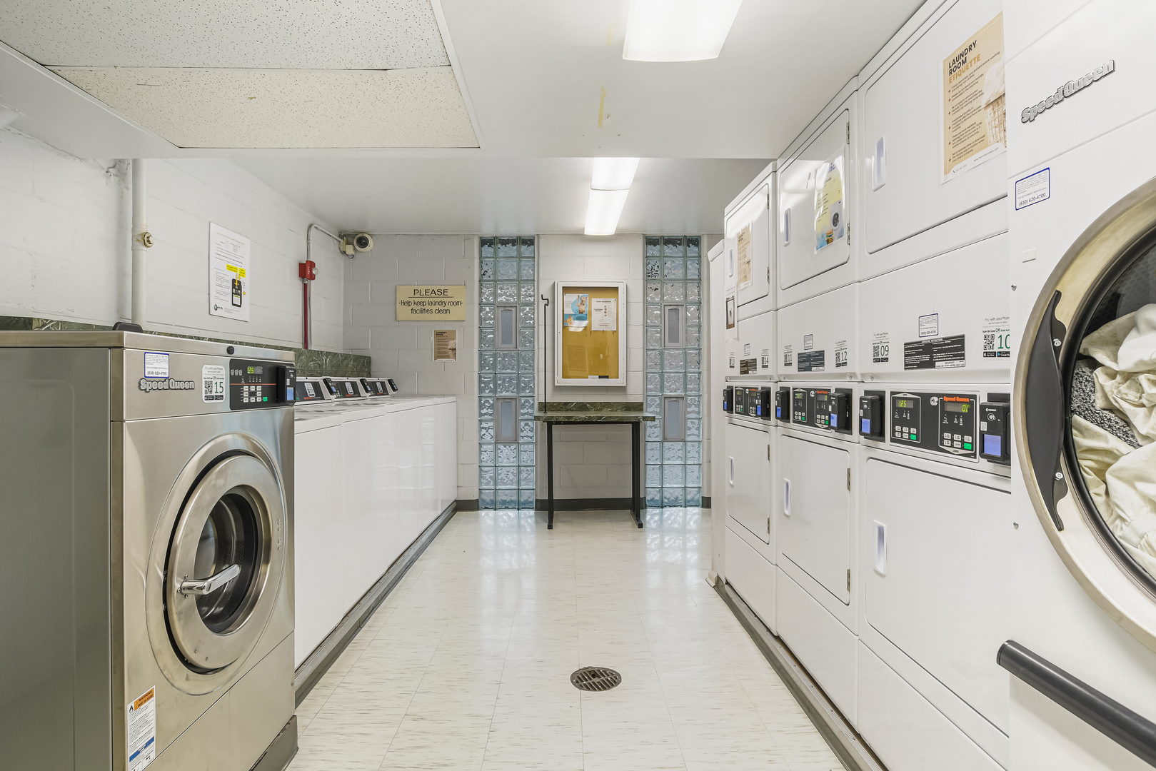 21 West Goethe Street, Unit 14D Chicago, IL 60610 - Photo 25 of 28 a view of washer and dryer with kitchen in the background