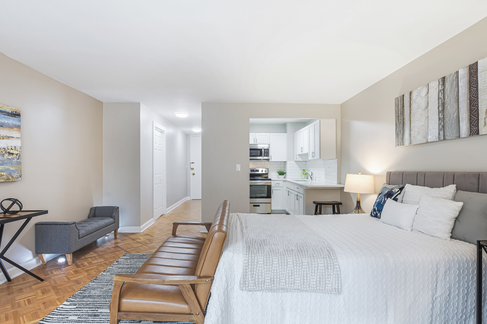 21 West Goethe Street, Unit 14D Chicago, IL 60610 - Photo 10 of 28 a bedroom with furniture and a wooden floor