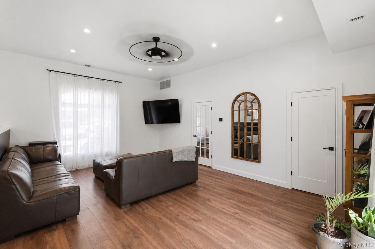18 Pond Road Holbrook, NY 11741 - Photo 12 of 41 Spacious living area featuring wood-finish flooring, recessed lighting, and a modern ceiling fan