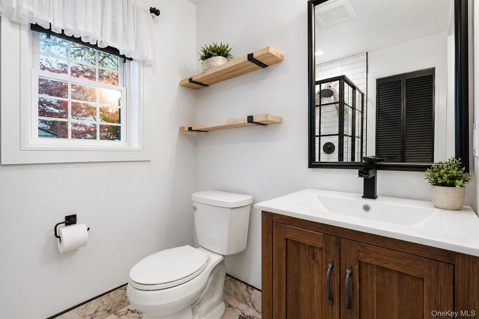 18 Pond Road Holbrook, NY 11741 - Photo 15 of 41 Bathroom featuring a wood-finish vanity with a white countertop and integrated sink