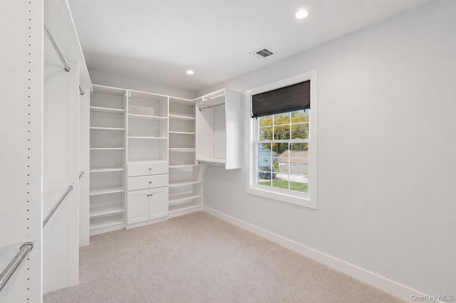 18 Pond Road Holbrook, NY 11741 - Photo 23 of 41 Primary Walk-in Closet, Custom built-in white shelving and cabinetry with ample storage
