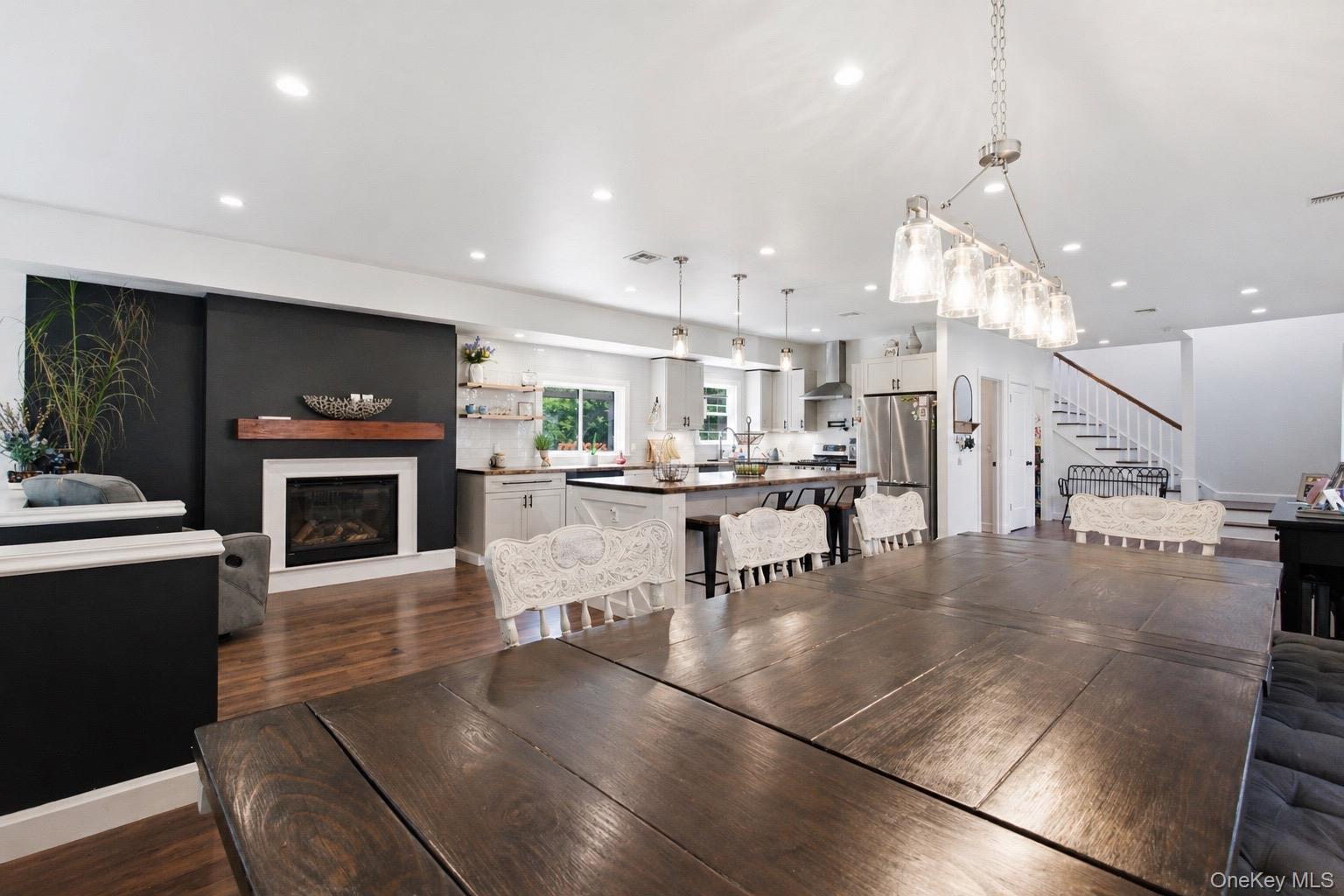 18 Pond Road Holbrook, NY 11741 - Photo 3 of 41 Open-concept living space featuring wood-finish flooring, recessed lighting, and a fireplace with a white mantel and wood shelf