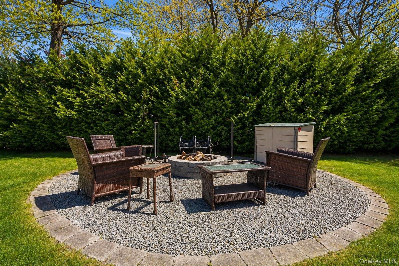 18 Pond Road Holbrook, NY 11741 - Photo 32 of 41 Circular gravel patio featuring a stone-clad fire pit