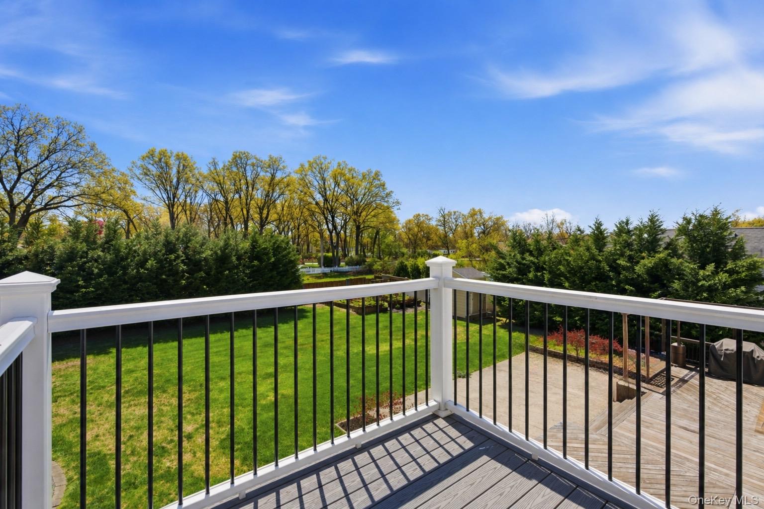 18 Pond Road Holbrook, NY 11741 - Photo 33 of 41 Balcony off the Primary Suite With composite planking and white railing with black metal balusters