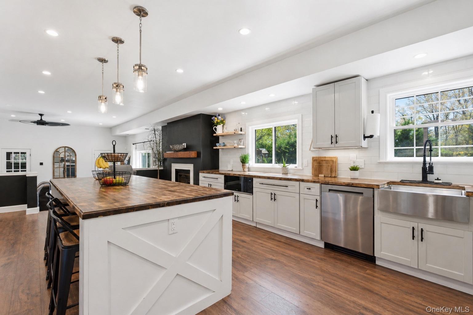 18 Pond Road Holbrook, NY 11741 - Photo 5 of 41 Kitchen featuring a large island with a wood-finish countertop, light gray cabinetry, stainless steel appliances, and a farmhouse sink