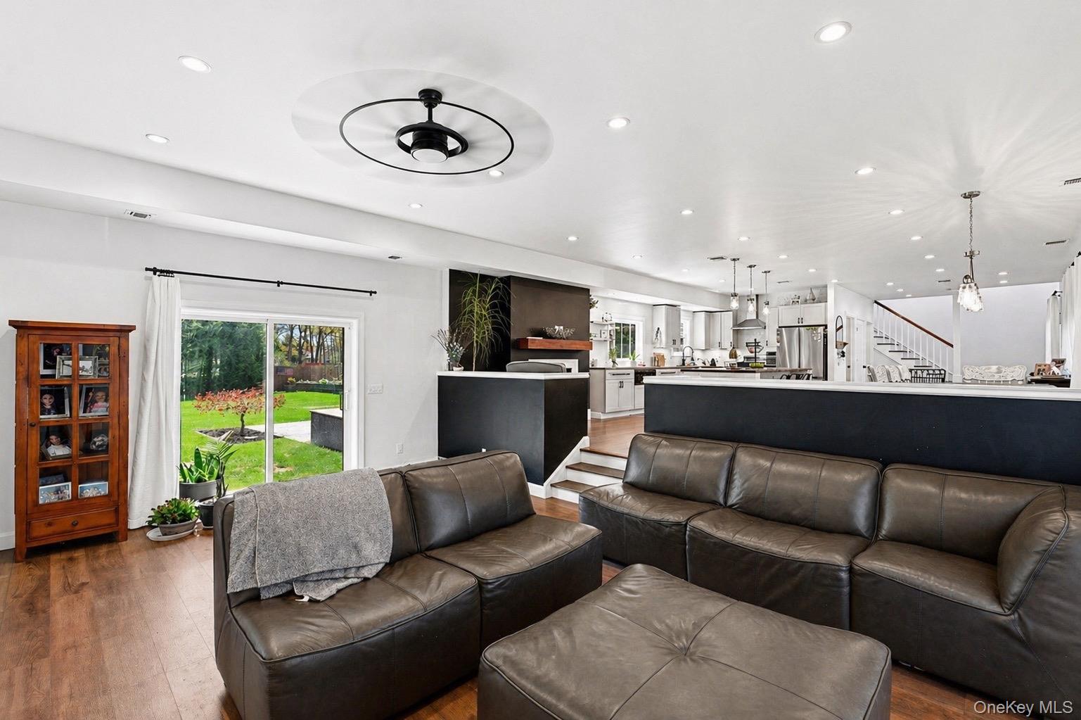 18 Pond Road Holbrook, NY 11741 - Photo 10 of 41 Open-concept living area featuring wood-finish flooring, recessed lighting, and a modern ceiling fan