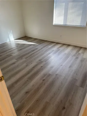 a view of a room with wooden floor and cabinet