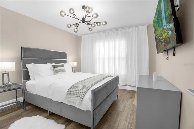 a large bed sitting in a bedroom next to a window