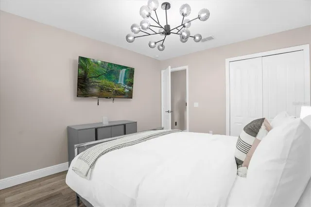 a bedroom with a bed and a flat screen tv