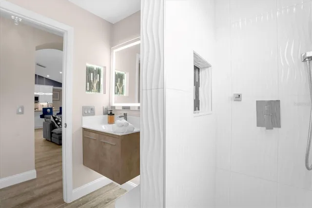 a bathroom with a sink a mirror and a shower