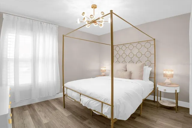 a bedroom with a bed and a window