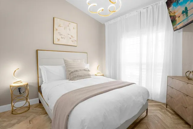 a bedroom with a bed and a night stand