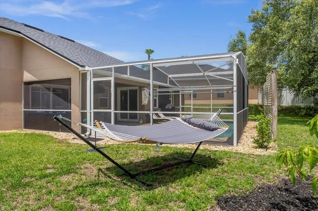 a view of a house with backyard and sitting area