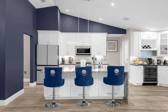 a kitchen with stainless steel appliances kitchen island microwave and cabinets