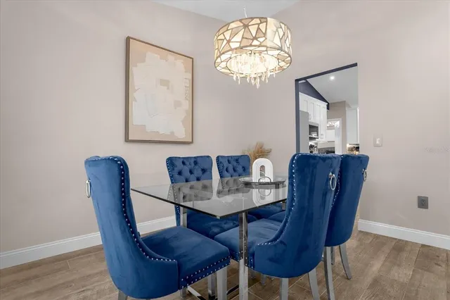 a dining room with furniture and chandelier